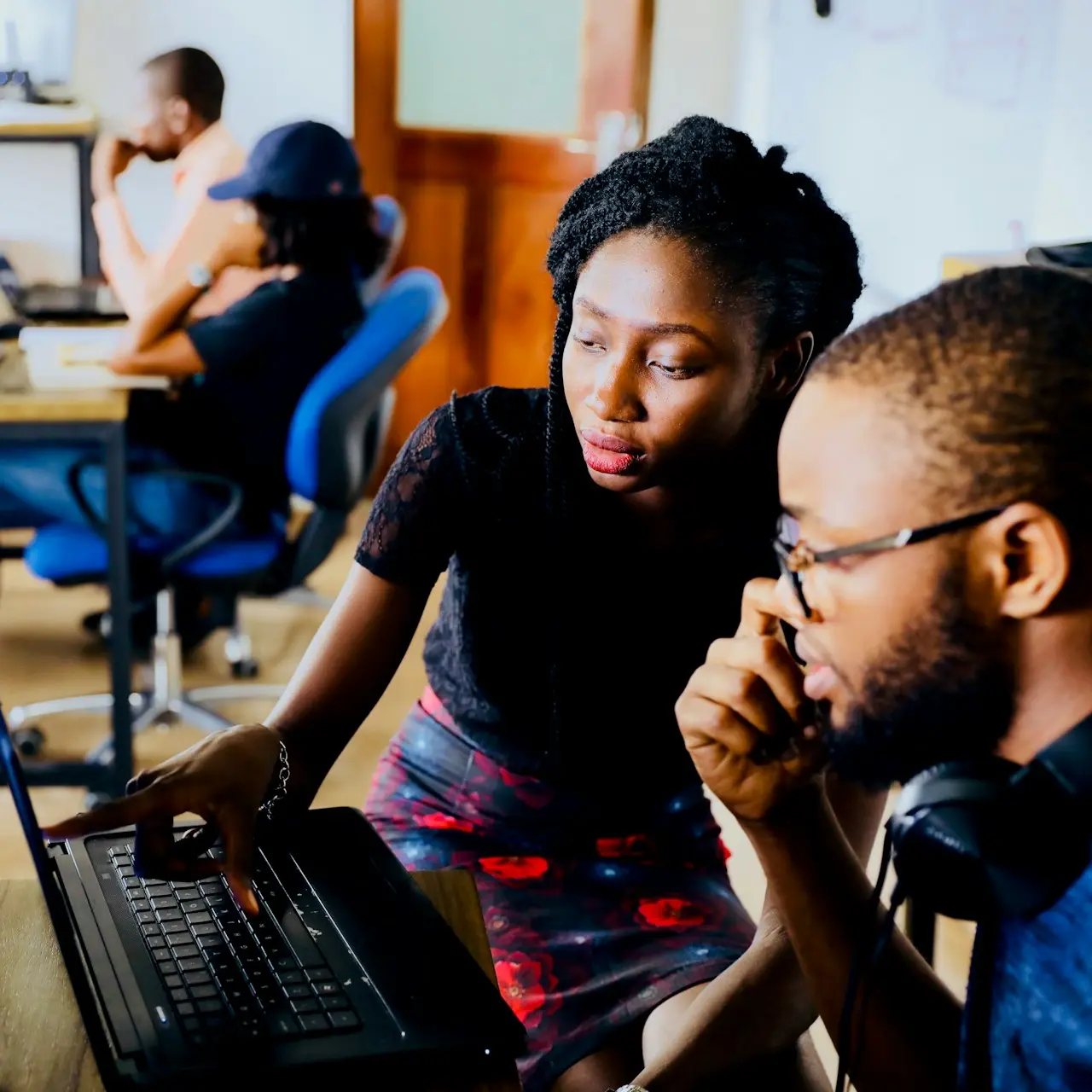 woman and man sitting in front of monitor