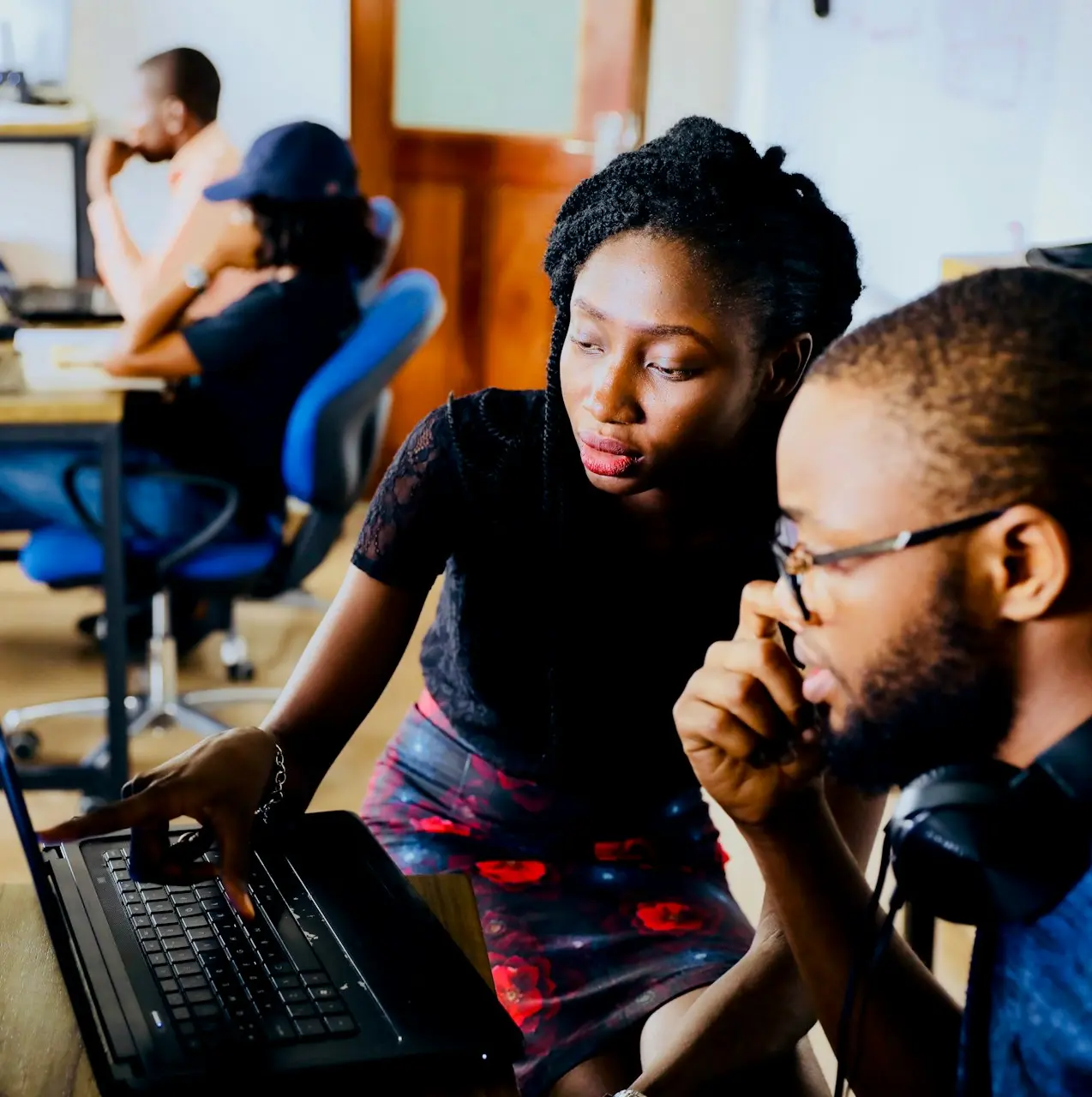 woman and man sitting in front of monitor